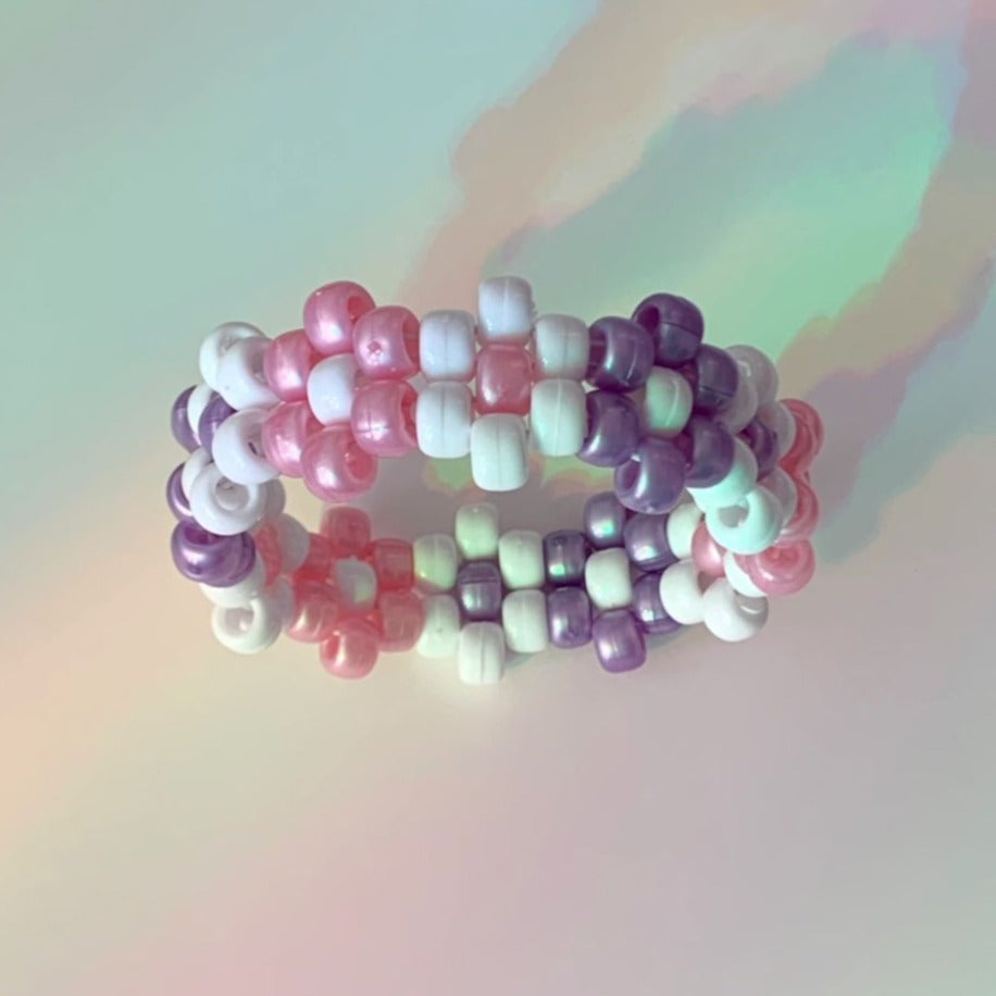 this baby pink, lavender & white flower kandi cuff is perfect for your next rave! look like the festival fairy princess you are with these soft pastel vibes
