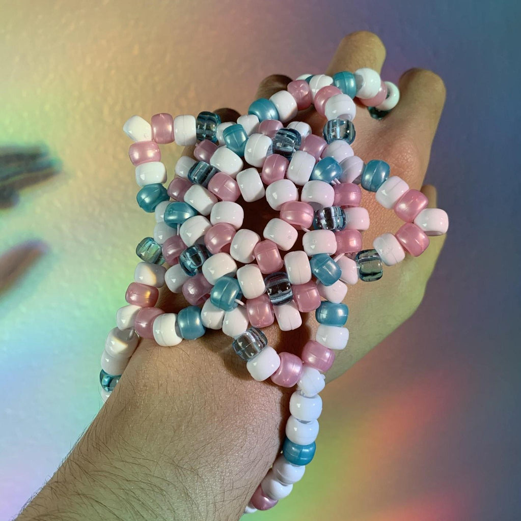 this rave fairy themed star hand kandi cuff is the perfect festival accessory for any festival fairy princess! the pony beads are various finishes like matte, shiny and translucent! the pastel pink, blue & white color scheme would go so well with any rave baby's fit